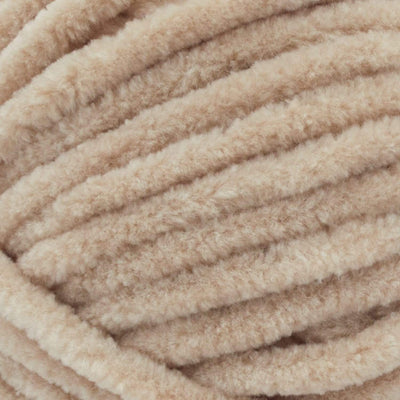 Close-up of Premier Parfait Chunky polyester yarn, highlighting the dense, plush pile and vibrant color in Toffee brown colou