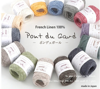 Multiple skeins of Pierrot Pont du Gard yarn, made from 100% French Linen, displayed in a variety of colors.