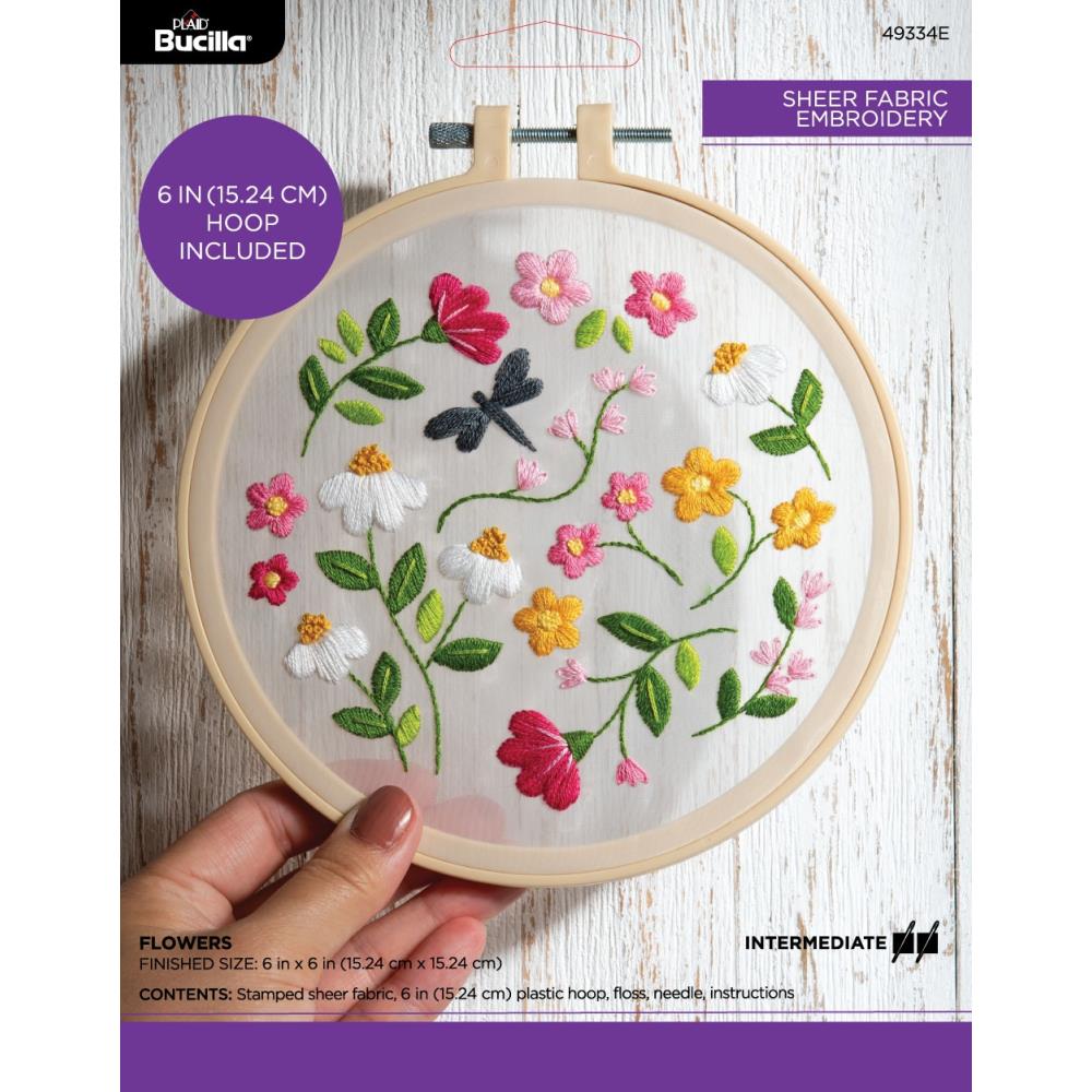 Packaging of a Bucilla stamped embroidery kit featuring a floral design, with a visible embroidery hoop and fabric.