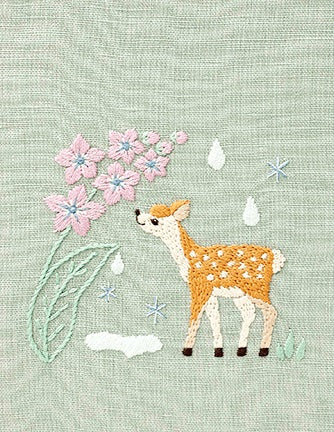 Embroidery kit depicting a cute animal, a deer, with flowers and water droplets on a pre-printed design on linen fabric.