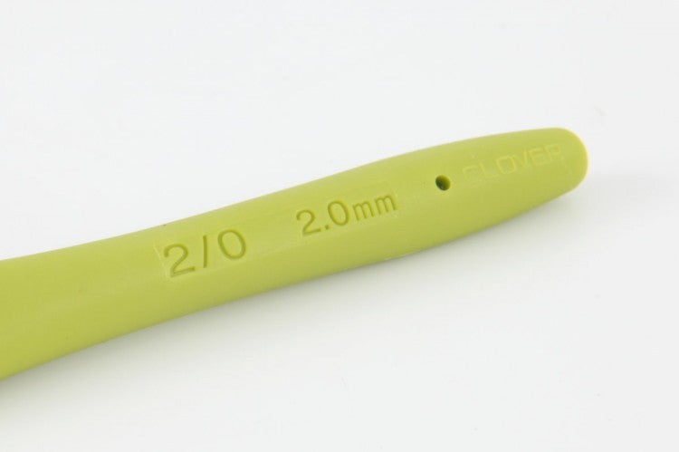 Japanese crochet tools, color-coded hooks. Close-up of the smooth, polished aluminum head of a Clover Amour hook showing the precision tip