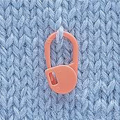 A bright orange Clover locking marker secured into a knit stitch, showing how the rounded tip prevents snagging on the yarn

Snag-free stitch markers, amigurumi round markers, Japanese knitting notions, colorful stitch clips, Clover craft supplies Singapore.