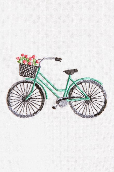 A charming intermediate DMC 3D embroidery kit featuring a vintage bicycle with a front basket filled with colorful, high-relief flowers. The design is worked on 25-count evenweave fabric using a mix of Size 5 and Size 8 Pearl Cotton in 6 vibrant colors. The kit includes a pre-printed pattern, needle, and instructions for a finished piece measuring 22 x 28 cm