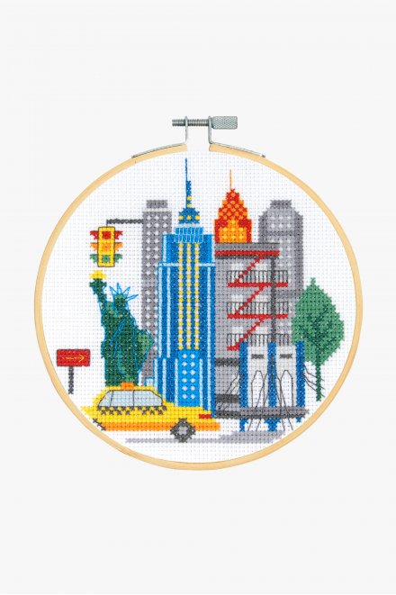 Cross stitch kit depicting a colorful image of a New York City skyline, including a 6-inch hoop for display.