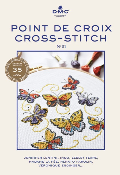 Cover of DMC Point De Croix/Cross Stitch Book N°1 featuring a completed cross stitch pattern with various colorful butterflies.