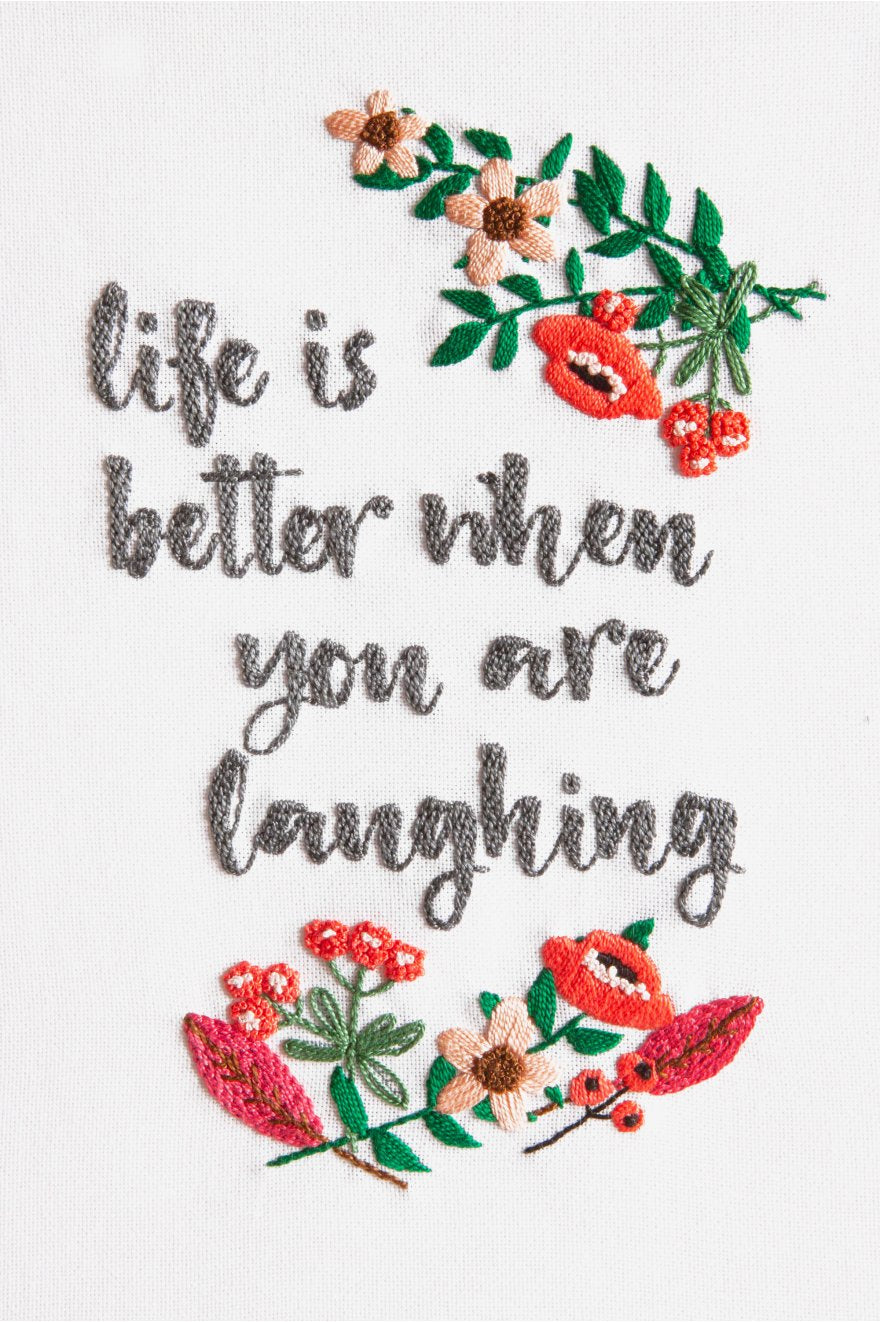 An advanced DMC 3D embroidery kit featuring a vibrant, colorful typographic design with the phrase 'Good Vibe' and the sub-text 'Life is better when you are laughing.' The design is worked in thick, lustrous Size 5 Pearl Cotton on a 25-count evenweave fabric. The kit includes 50 skeins of thread in 9 bright colors, a printed pattern, and a needle for a finished size of 18x28 cm