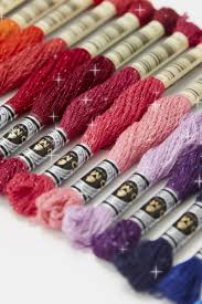 A single 8-meter skein of DMC Mouliné Étoile embroidery thread. The floss is composed of 6 easily separable strands, featuring a unique blend of high-quality cotton and shimmering lurex fibers.