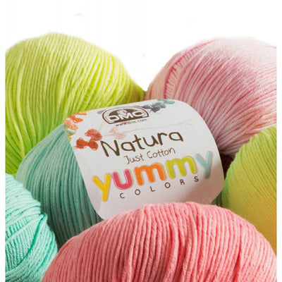 A 50g ball of DMC Natura Just Cotton yarn, showcasing its smooth, matte texture and multi-ply combed cotton fibers. The image highlights the natural, non-mercerized finish and the sophisticated, muted color tones ideal for lightweight garments, amigurumi, and home decor