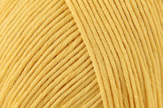 DMC Natura Just Cotton fingering weight yarn, ideal for detailed amigurumi and breathable summer garments, shown in a 50g ball in "tournesol" yellow colour