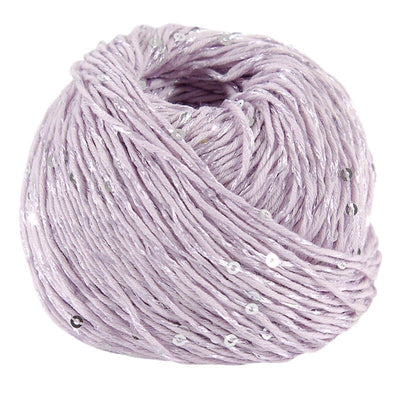 Macro shot of DMC Natura Glam fibers, highlighting the small, flat sequins that are seamlessly integrated into the cotton blend for a subtle sparkle in lilac purple colour