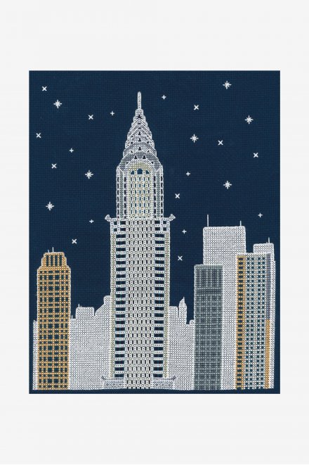 DMC New York by Night kit packaging showing a stitched Empire State Building and Manhattan skyline on navy fabric
A split-screen view of the New York cross stitch kit, showing the vibrant city by day and the luminous glow-in-the-dark stars by night