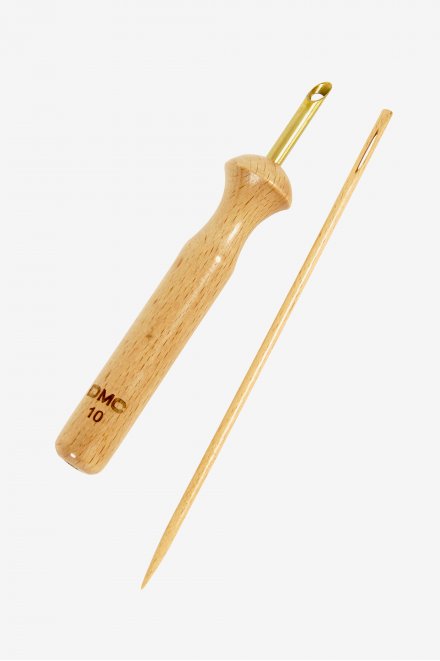 A DMC Punch Needle No. 10 with a wooden handle and a steel tip, alongside a wooden needle, against a white background.