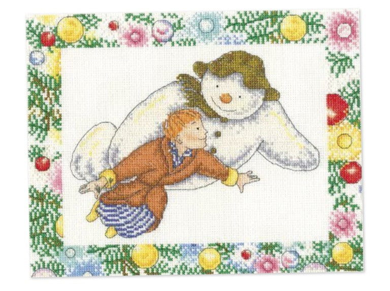 A magical DMC counted cross-stitch kit featuring Raymond Briggs’ The Snowman and the boy flying over a snowy landscape. The design is stitched on 14-count iridescent Aida cloth that sparkles like real snow. The kit includes pre-sorted DMC stranded cotton threads, a needle, a clear chart, and instructions for a 10x8 inch finished piece.