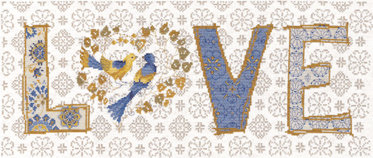 A panoramic Design Works counted cross-stitch kit featuring the word 'Love' in a large, elegant script. The letters are intertwined with a variety of colorful flowers and delicate greenery. The kit includes 14-count white Aida fabric, pre-sorted embroidery threads, a needle, and instructions for a unique 20-inch wide finished piece