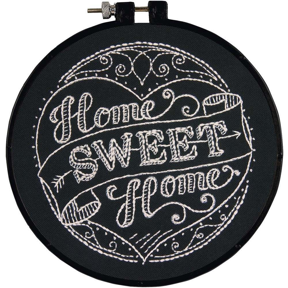 Embroidery hoop with 'Home Sweet Home' text in white on a black background, enclosed in a 6-inch plastic hoop.
