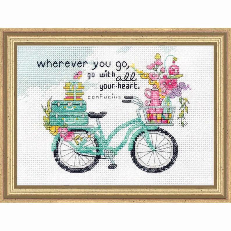 An uplifting Dimensions counted cross-stitch kit featuring the inspirational quote 'Wherever you go, go with all your heart.' The text is surrounded by a whimsical border of colorful flowers and delicate greenery. The kit includes 14-count white Aida fabric, pre-sorted cotton embroidery floss, a needle, and easy instructions for a 5x7 inch finished piece