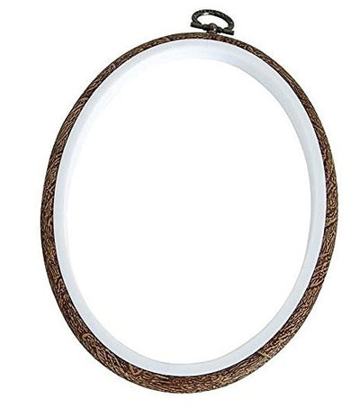 An oval embroidery hoop with a wood grain appearance on the outer layer, designed to hold fabric for embroidery work.