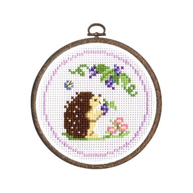 Beginner Cross Stitch Kit with Hoop, 9 Count Aida Kit, Japanese Animal Embroidery, Hedgehog Needlework

A finished Hedgehog project framed in its 6-inch hoop, displayed as a wall decoration in a cozy, modern craft space