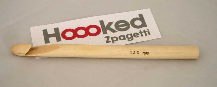 Singapore crochet supplies.
Packaged DMC Hoooked Zpagetti Wooden Crochet Hook, beige in color, displayed in a clear plastic case with a white background.
"A large, professional-grade DMC Hoooked Zpagetti crochet hook made from smooth, light-grained natural wood.