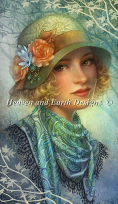 A cross-stitch pattern image featuring a woman with a floral hat and a green and blue scarf, labeled 'Heaven and Earth Designs'.