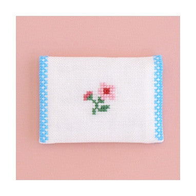 A hand-stitched Olympus card case holding business cards, demonstrating its elegant size and practical everyday use