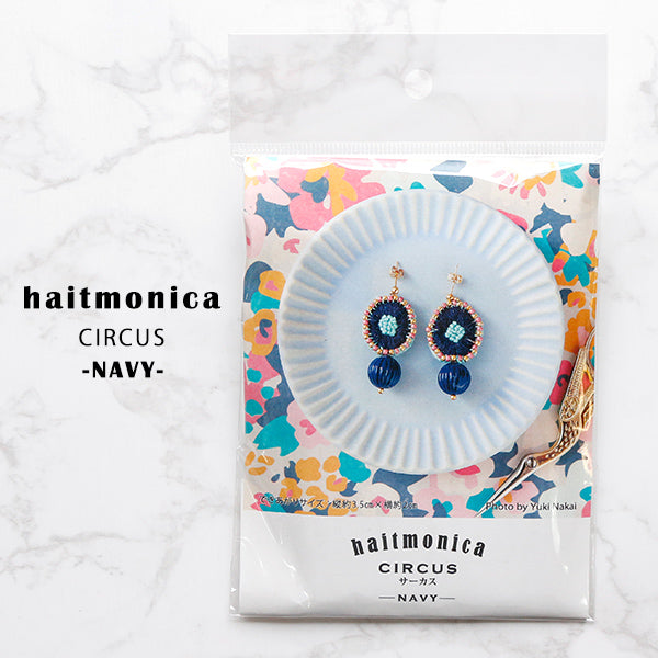 A charming Japanese DIY craft kit by Haitmonika for creating hand-embroidered earrings. The image shows high-quality felt, colorful embroidery threads, delicate beads, and unique German acrylic accents, all laid out with beautifully illustrated Japanese instruction sheets