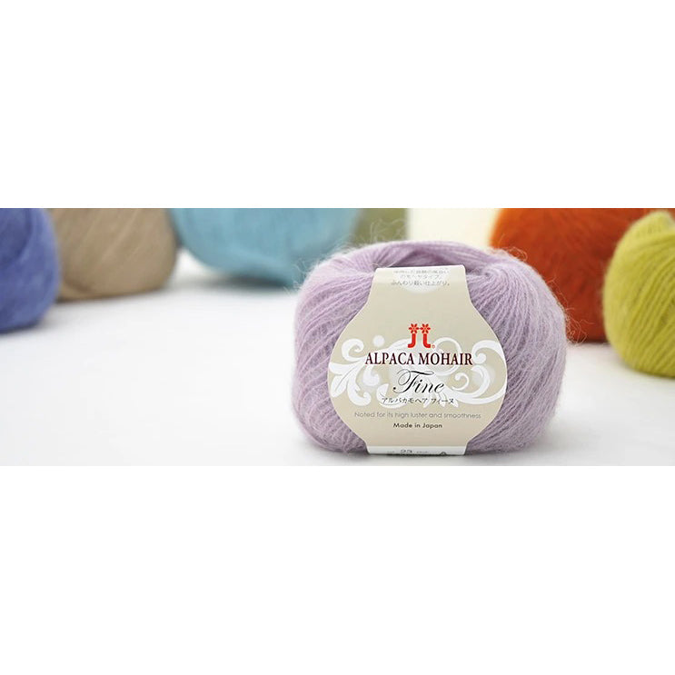 A 25g ball of Hamanaka Alpaca Mohair Fine yarn, showcasing its soft, fuzzy halo and fine, delicate strand. The image highlights the airy texture created by the blend of goat mohair and high-grade alpaca, perfect for knitting or crocheting lightweight, fluffy wearables like scarves, vests, and cardigans
