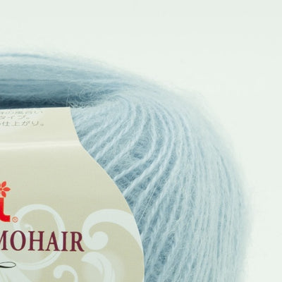 A 25g ball of Hamanaka Alpaca Mohair Fine yarn, showcasing its soft, fuzzy halo and fine, delicate strand. The image highlights the airy texture created by the blend of goat mohair and high-grade alpaca, perfect for knitting or crocheting lightweight, fluffy wearables like scarves, vests, and cardigans