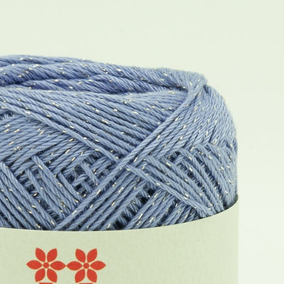 A 30g ball of Hamanaka Aprico Lame yarn made in Japan, showing the fine cotton strand entwined with a subtle metallic shimmer for a sophisticated sparkle in lavender colour