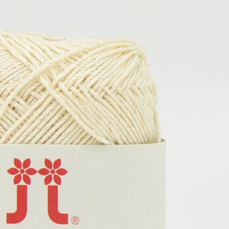 A compact ball of Japanese Aprico Lame cotton yarn, highlighting the vibrant color and the elegant, understated sparkle of the integrated metallic fibers in creamy yellow
