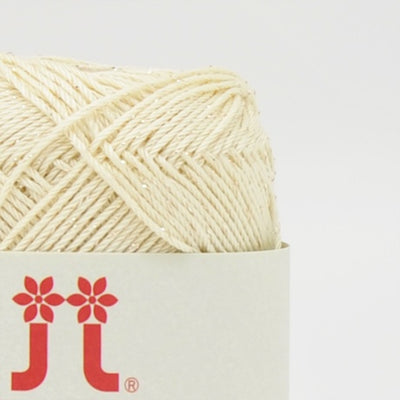 A compact ball of Japanese Aprico Lame cotton yarn, highlighting the vibrant color and the elegant, understated sparkle of the integrated metallic fibers in creamy yellow