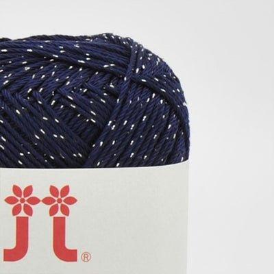 A 30g ball of Hamanaka Aprico Lame yarn made in Japan, showing the fine cotton strand entwined with a subtle metallic shimmer for a sophisticated sparkle in Dark Navy Blue colour