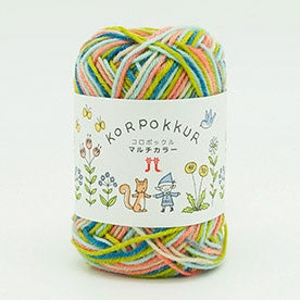 A skein of multicolored wool yarn with a label that includes floral and garden graphics, and the brand name 'KORPOKKUR'.