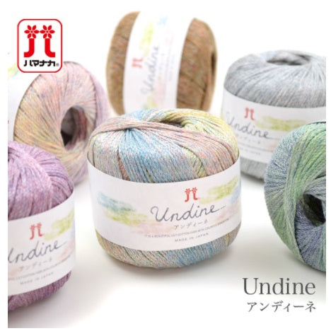 Several skeins of Hamanaka Undine yarn in various colors, each labeled with the brand and product name.
