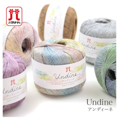 Several skeins of Hamanaka Undine yarn in various colors, each labeled with the brand and product name.