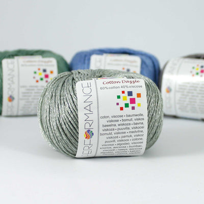 A 50g skein of Cotton Dazzle yarn in a vibrant shade, showcasing the subtle reflective shimmer and smooth plied texture of the cotton-viscose blend in silver grey colour