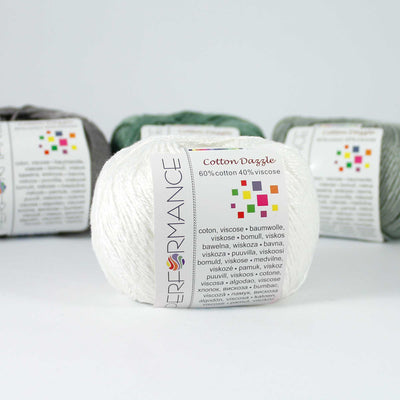 A 50g skein of Cotton Dazzle yarn in a vibrant shade, showcasing the subtle reflective shimmer and smooth plied texture of the cotton-viscose blend in white colour