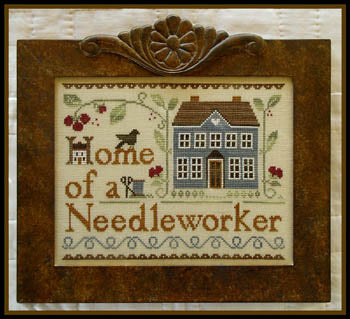 A professional cross-stitch chart for a traditional-style sampler titled 'Home of a Needleworker (too).' The high-definition design features the central motto in elegant typography, surrounded by artisanal motifs such as a Colonial House, birds, and decorative folk-art borders.