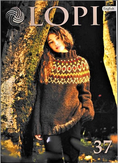 A cover image of Lopi's Knitting Book Vol.37 featuring a person wearing a knitted sweater with a geometric pattern, standing beside a tree. Model wearing a sweater featuring rustic Icelandic sweater in subtle earthy tones, set against a fall forest background