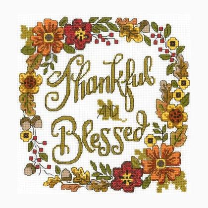 Cross stitch kit depicting a floral design with the text 'Thankful & Blessed' in a decorative font, surrounded by a border of autumn floral elements.
