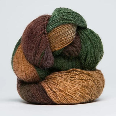 A skein of Jade Sapphire 100% Cashmere Yarn in a hand-dyed colorway, featuring shades of green, brown, and beige.