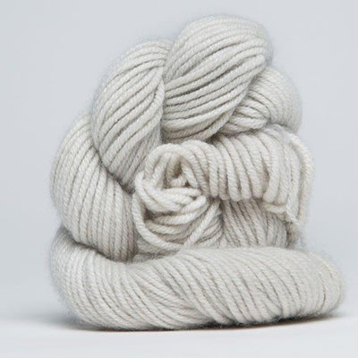 A skein of Jade Sapphire 100% Cashmere Yarn in a hand-dyed colorway, featuring shades silver white colour