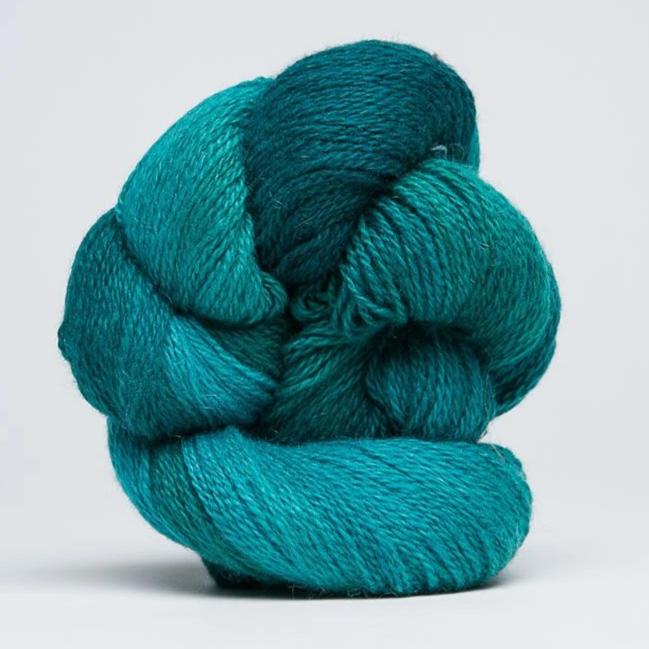"A delicate skein of hand-dyed Jade Sapphire yarn, showcasing a sophisticated blend of 55% silk and 45% cashmere in Caribbean green mist colours