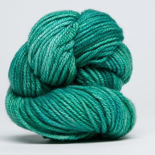 "A delicate skein of hand-dyed Jade Sapphire yarn, showcasing a sophisticated blend of 55% silk and 45% cashmere in Jade Green Colour