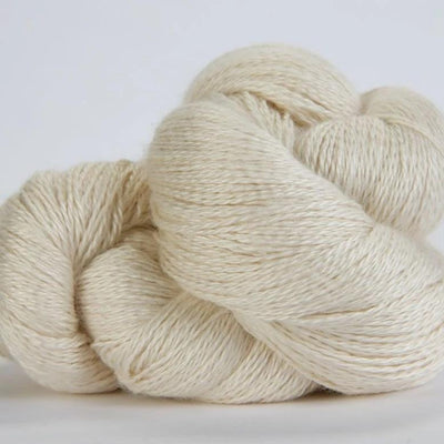 Jade Sapphire hand-dyed 50% silk and 50% yak lace yarn from Mongolia; a 100g skein with 700 yards for premium lace knitting."
"Close-up of hand-dyed Jade Sapphire exotic fiber yarn in Off White, showing the unique tonal variations and silken luster of the yak-silk blend."