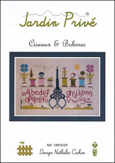 A professional-grade cross-stitch chart by Jardin Prive titled 'Sampler-Scissors & Bobines.' The high-definition French-style sampler features a large, ornate pair of scissors as the central 'statement piece.' The design is richly accented with artisanal motifs including vintage spools of thread (bobines), symmetric trees, alphabet letters, charming sheep, traditional houses, and delicate floral borders.