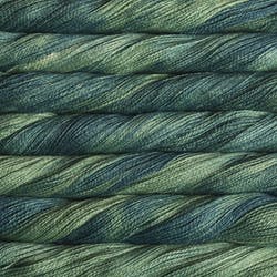 A collection of Malabrigo Silpaca skeins in various kettle-dyed colorways, demonstrating the rich depth and artistic tonal shifts in solis, green hues colour