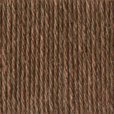 A skein of Lily Sugar N' Cream 100% cotton yarn in warm brown color. The texture is soft yet sturdy, showing the natural matte finish of the cotton fibers. The packaging clearly displays the Lily brand logo and weight options, ideal for durable kitchen and bathroom DIY projects.