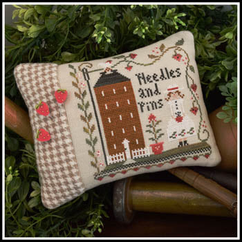 A professional cross-stitch kit by Little House Needleworks titled 'Keeper of the Pins.' The design features a charming, primitive-style sampler motif with a central focus on needlework tools and delicate borders. The kit is a comprehensive 2018 Nashville Market exclusive, including the original chart, a curated selection of hand-dyed cotton threads from Classic Colorworks, and two decorative 'Strawberry Counting Pins' from Just Another Button Company.