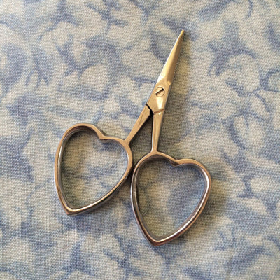 A pair of scissors with heart-shaped handles, lying on a blue patterned surface.

Best sharp scissors for cross stitch Singapore, heart handle scissors for thread, buy boutique embroidery snips onlin